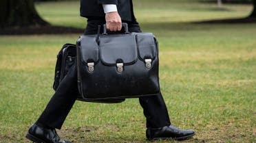A military aide carries the “nuclear football,” which contains launch codes for nuclear weapons, while walking to Marine One on the South Lawn of the White House October 3, 2022 in Washington, DC. (AFP)