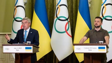 Ukrainian President Volodymyr Zelenskyy and President of the International Olympic Committee Thomas Bach attend a joint news briefing during a parliament session in Kyiv, Ukraine, on July 3, 2022. (Ukrainian Presidential Press Service via Reuters)
