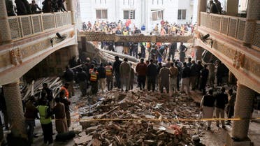 People and rescue workers gather to look for survivors under a collapsed roof, after a suicide blast in a mosque in Peshawar, Pakistan January 30, 2023. (Reuters)