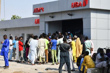 People queue to withdraw new Naira notes at an ATM in Maiduguri on January 29, 2023. (AFP)