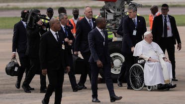 Pope Francis (R), seated on a wheelchair, arrives at the N’djili International Airport in Kinshasa, Democratic Republic of Congo (DRC), on January 31, 2023. (AFP)