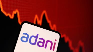 Adani logo and decreasing stock graph is seen in this illustration on January 31, 2023. (Reuters)