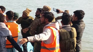 In this picture taken on January 30, 2023, a rescue team carries the recovered body (C) of a student who drowned after a boat capsized in Tanda Dam in Kohat district of northern Khyber Pakhtunkhwa province. (AFP)