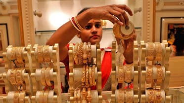 A saleswoman shows gold bangles to a customer at a jewellery showroom on the occasion of Akshaya Tritiya, a major gold buying festival, in Kolkata, India. (File photo: Reuters)