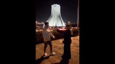 Astiazh Haghighi and Amir-Mohammad Ahmadi dancing near Tehran’s Azadi Square. (Screengrab/Twitter)