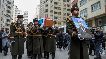 Honor guards carry a portrait and a coffin with the body of Orkhan Askerov, a security officer at Azerbaijan’s embassy in Iran shot dead by a gunman in a recent attack, during a procession prior to a funeral in Baku, Azerbaijan, January 30, 2023. (Reuters)