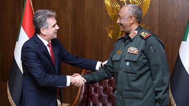 A handout picture released by the Sovereign Council of Sudan, shows Sudan’s army chief Abdel Fattah al-Burhan (R) receiving Israeli Foreign Minister Eli Cohen in the capital Khartoum, on February 2, 2023. (Sovereign Council of Sudan via AFP)
