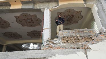 A police officer stands amid damaged structure, following a suicide blast in a mosque in Peshawar, Pakistan, on February 1, 2023. (Reuters)