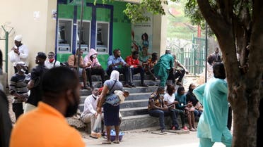 People sit outside ATM booths at Wuse market in Abuja, Nigeria February 2, 2021. (File photo: Reuters)