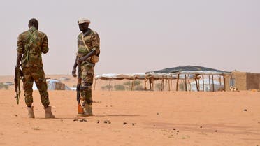 Niger soldiers stand guard during a visit by the Interior Minister Mohamed Bazoum on October 21, 2016 to the in Tazalit United Nations refugee camp in the Tahoua region some 300 kilometres northeast of the capital Niamey, Niger. (AFP)