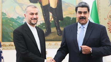 This handout picture released by Miraflores Palace press office shows Venezuelan President Nicolas Maduro (R) shaking hands with Iran's Foreign Minister Hossein Amir-Abdollahian (L) before a meeting at the Miraflores presidential palace in Caracas on February 3, 2023. (AFP)