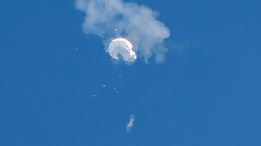 A jet flies by a suspected Chinese spy balloon as it floats off the coast in Surfside Beach, South Carolina, February 4, 2023. (Reuters)
