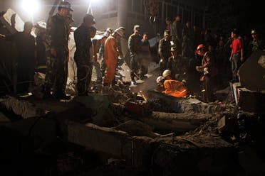 Rescuers search for victims at a collapsed school building after an earthquake in Dujiangyan, Sichuan province May 12, 2008. (Reuters)