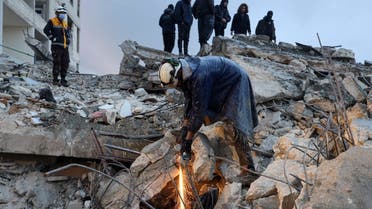 Members of the Syrian civil defense, known as the White Helmets look for casualties under the rubble following an earthquake in the town of Zardana in the countryside of the northwestern Syrian Idlib province, early on February 6, 2023. (AFP)