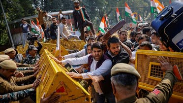 Activists of the youth wing of India’s main opposition Congress party try to break a police barricade during a protest against what they say are investments by Life Insurance Corporation (LIC) and State Bank of India (SBI) in Adani Group, in New Delhi, India, on February 6, 2023. (Reuters)