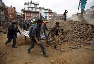 People carry the body of a victim on a stretcher, which was trapped in the debris after an earthquake hit, in Kathmandu, Nepal April 25, 2015. (Reuters)