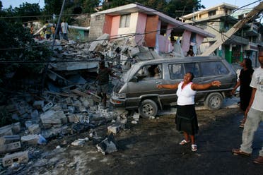 A woman reacts near destroyed buildings after an earthquake in Port-au-Prince January 13, 2010. (Reuters)
