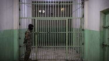 A member of the Syrian Democratic Forces (SDF) stands guard in a prison where men suspected to be afiliated with the ISIS group are jailed in northeast Syria in the city of Hasakeh on October 26, 2019. (AFP)