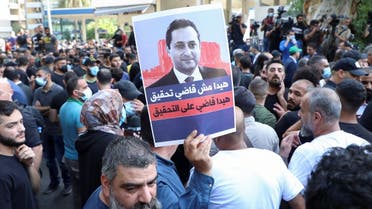 Supporters of Lebanese Shia Hezbollah and Amal and the Christian Marada Movement take part in a protest against Tarek Bitar, the lead judge of the port blast investigation, October 14, 2021. (Reuters)