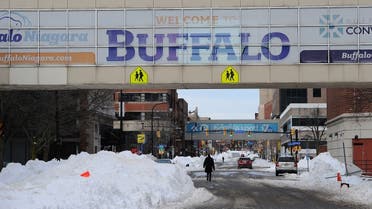 Pedestrians walk along Ellicott Street in downtown Buffalo on December 28, 2022 in Buffalo, New York. (AFP)