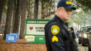 A Newport News police officer directs traffic at Richneck Elementary School in Newport News, Va., on Monday Jan. 30, 2023. The Virginia elementary school where a 6-year-old boy shot his teacher has reopened with stepped-up security and a new administrator. (AP)