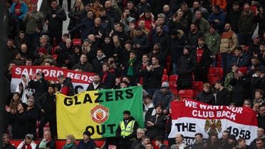 Manchester United fans display a Glazers out sign before the match. (Reuters)