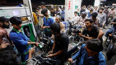 People wait their turn to get fuel at a petrol station, in Karachi, Pakistan June 2, 2022. (Reuters)