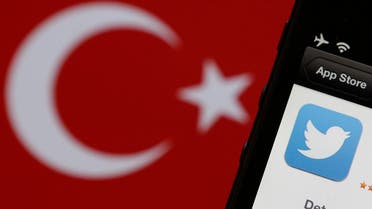 A Twitter logo on an iPhone display is pictured next to a Turkish flag in this photo illustration taken in Istanbul March 21, 2014. (Reuters)