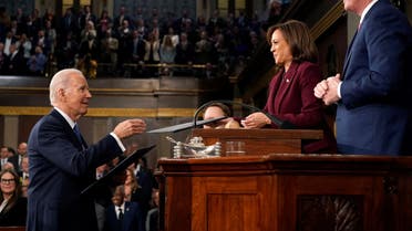 President Joe Biden hands copies of his speech to Vice President Kamala Harris and House Speaker Kevin McCarthy of Calif., at the State of the Union address to a joint session of Congress at the Capitol, Tuesday, Feb. 7, 2023, in Washington. (Reuters)