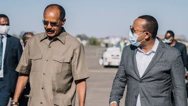 A handout picture released by Office of the Prime Minister Ethiopia on March 26, 2021, shows Ethiopia’s Prime Minister Abiy Ahmed (R) and Eritrea’s President Isaias Afwerki speaking upon the arrival of the latter for a bilateral meeting at Asmara International Airport in Asmara on March 25, 2021. (Office of the Prime Minister Ethiopia/AFP)