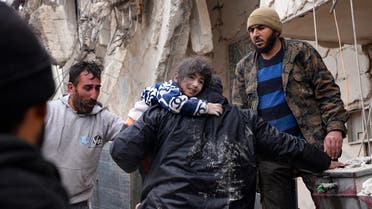 Residents retrieve a small child from the rubble of a collapsed building following an earthquake in the town of Jandaris, in the countryside of Syria’s northwestern city of Afrin in the opposition-held part of Aleppo province, on February 6, 2023. (AFP)
