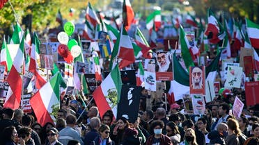 Protesters hold up a placard showing Kurdish Iranian woman Mahsa Amini who died while in the custody of Iran’s morality police, in a rally in support of the demonstrations in Iran, in Berlin, Germany on October 22, 2022. (AFP)