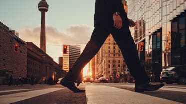 Stock image of a man walking in Toronto, Canada. (Unsplash, Arturo Castaneyra)