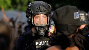 A policeman faces a protester during nationwide unrest following the death in Minneapolis police custody of George Floyd, in Raleigh, North Carolina, U.S. May 30, 2020. Picture taken May 30, 2020. REUTERS/Jonathan Drake