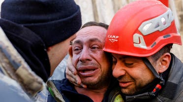 A man reacts next to rescuers in the aftermath of a deadly earthquake in Hatay, Turkey February 11, 2023. (Reuters)