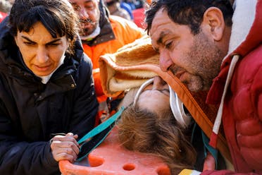 Rescuers attend to survivor Muzeyyen Ofkeli in the aftermath of a deadly earthquake, in Hatay, Turkey, on February 12, 2023. (Reuters)
