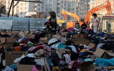 People look for suitable clothes among aid in the aftermath of the deadly earthquake in Hatay province, Turkey, on February 12, 2023. (Reuters)