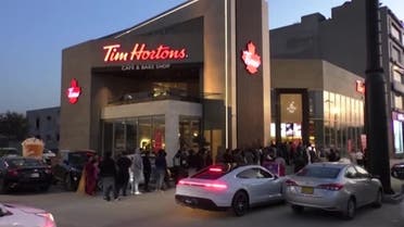 Queues in front Tim Hortons café since it opened on Saturday, February 11 at an upmarket Lahore shopping mall, Pakistan. (Reuters)