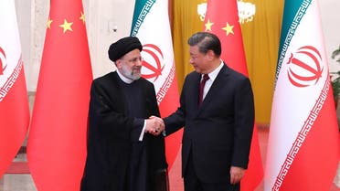 This handout picture provided by the Iranian presidency shows Chinese President Xi Jinping welcoming the Islamic Republic’s President Ebrahim Raisi (L) during his visit in Beijing on February 14, 2023. (AFP)