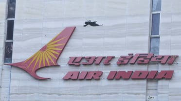 A bird flies over a logo of Air India airlines at the corporate headquarters in Mumbai, India, October 19, 2021. (Reuters)