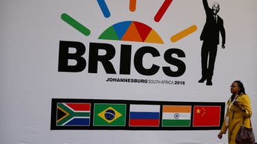 A delegate walks past a BRICS logo ahead of the 10th BRICS Summit, in Sandton, South Africa, on July 24, 2018. (Reuters)