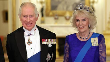 Britain's King Charles III and Britain's Camilla, Queen Consort wearing a brooch depicting an image of the late Queen Elizabeth II, pose for a photograph during a State Banquet at Buckingham Palace in London on November 22, 2022. (Photo by Chris Jackson / POOL / AFP) RELATED CONTENT