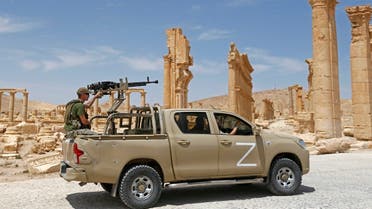 A Russian forces’ “technical” (pickup truck mounted with a turret) drives past the remains of the Triumphal Arch of Septimius Severus built during the reign of the 3rd-century Roman emperor, and destroyed by ISIS militants in 2015, in the ruins of Syria’s Roman-era ancient city of Palmyra. (AFP)