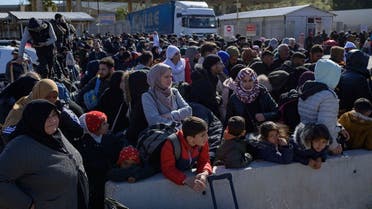 Syrian residents of Hatay city wait to cross the Turkish-Syrian border after they were affected by the 7.8-magnitude earthquake that struck the region nearly two weeks ago, at Cilvegozu border gate on February 17, 2023. (AFP)