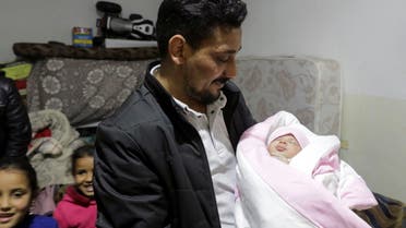 Khalil al-Sawadi, the uncle-by-marriage of a baby girl born during a deadly earthquake earlier this month, holds her, in opposition-held town of Jandaris, Syria February 18, 2023. (Reuters)