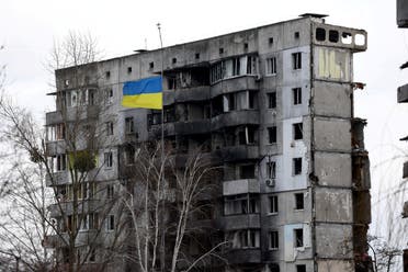 A Ukrainian national flag flies in front of a destroyed residential building amid Russia's invasion of Ukraine, in Borodianka, Kyiv region, Ukraine, February 18, 2023. 