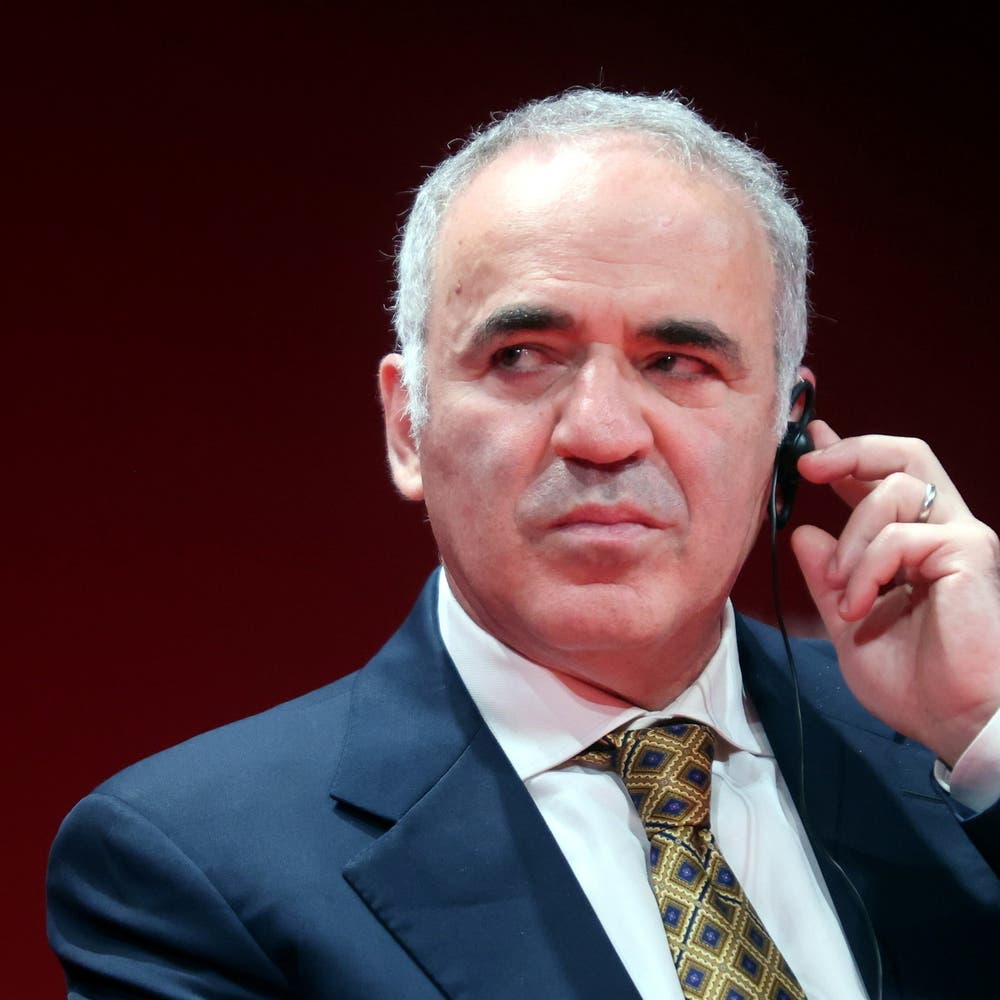 Former World Chess Champion, Garry Kasparov, right, talks to the