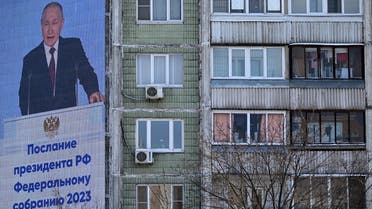 Russian President Vladimir Putin is seen on an outdoor screen on the facade of a building delivering his annual state of the nation address in Moscow on February 21, 2023. (AFP)