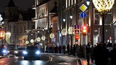 People walk on a street with shops and restaurants in central Moscow on February 4, 2023. (AFP)