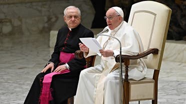 Pope Francis (R), assisted by Prefect of the Pontifical House Monsignor Leonardo Sapienza (L), speaks during the weekly general audience at Paul-VI hall in The Vatican on February 22, 2023. (AFP)